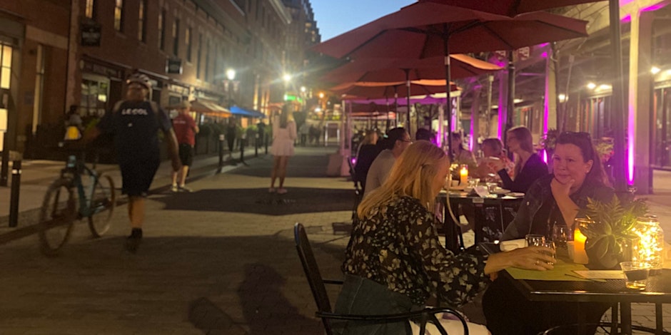 Tables and chairs are set up on Market St. where people are dining under the stars